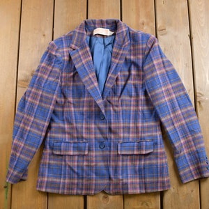 May include: A blue and pink plaid blazer with two button closures and two pockets.