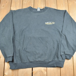 May include: A black long-sleeved sweatshirt with a gold embroidered logo that reads "Purdue Boilermakers" on the front.