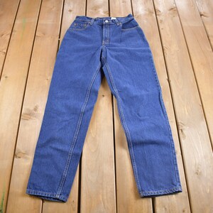 May include: A pair of blue denim jeans with a high waist and straight legs.