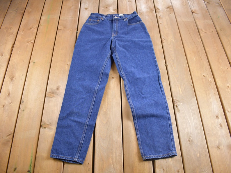 May include: A pair of blue denim jeans with a high waist and straight legs.