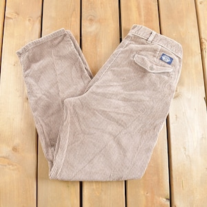 May include: A pair of brown corduroy trousers with a small blue patch on the back pocket.