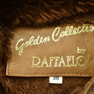 May include: A brown leather jacket with a fur collar. The label reads "Golden Collection by Raffaello" and has a size tag that says "38".