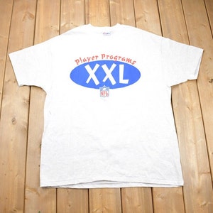 May include: A white t-shirt with a blue oval and the text "Player Programs XXL" in red and blue. The NFL logo is in the center of the oval.