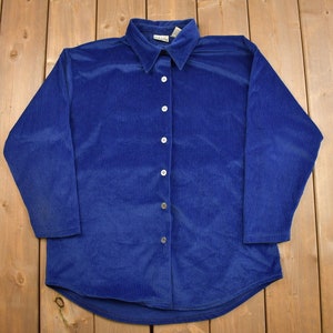 May include: A long-sleeved, blue corduroy button-down shirt.