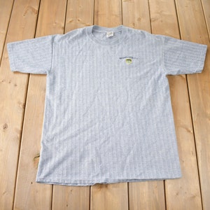 May include: Grey striped t-shirt with a small embroidered logo that says "Washington D.C."