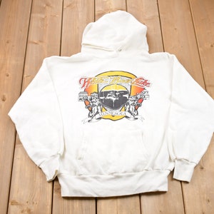 May include: White hooded sweatshirt with a graphic print of a crest featuring a lake scene and the text "White Bear Lake, Minnesota".