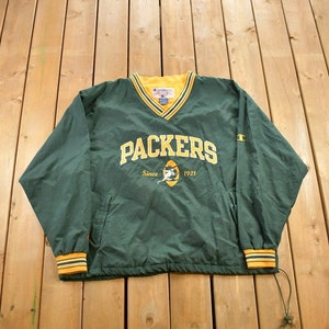 May include: Green and yellow Champion windbreaker with the words "Packers" and "Since 1921" on the front.