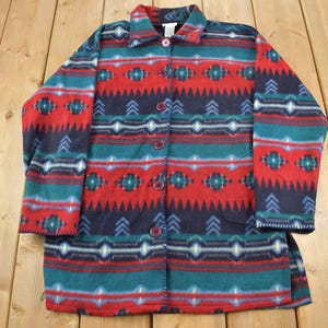 May include: A red, blue, and green fleece jacket with a southwestern pattern. The jacket has a button-up front and two pockets.