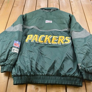 May include: Green and yellow NFL Pro Line Packers jacket with a zipper closure and a gray stripe across the back.