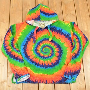 May include: A vibrant tie-dye hoodie featuring a spiral pattern in orange, green, blue, and purple. The hooded sweatshirt has a drawstring and a front pocket. The cuffs and hood lining are white. The hoodie is made of a soft, comfortable material.
