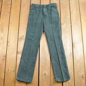 May include: A pair of dark blue denim jeans with a straight leg fit.