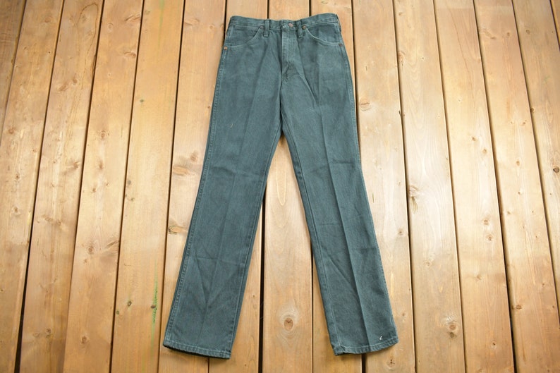 May include: A pair of dark blue denim jeans with a straight leg fit.