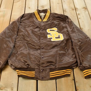 May include: Brown satin jacket with yellow and brown striped trim. The jacket features a large yellow and brown "SD" logo on the chest. The collar and cuffs have yellow and brown stripes.