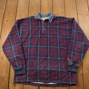 May include: A long-sleeved plaid shirt with a denim collar. The shirt is a mix of burgundy, blue, and white plaid.