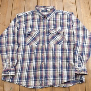 May include: A long-sleeved plaid shirt in blue, red, and white with two chest pockets.