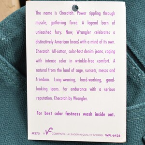 May include: A white tag with purple text describes Checotah jeans. The tag says "The name is Checotah. Power rippling through muscle, gathering force. A legend born of unleashed fury. Now, Wrangler celebrates a distinctively American breed with a mind of its own. Checotah. All-cotton, color-fast denim jeans, raging with intense color in wrinkle-free comfort. A natural from the land of sage, sunsets, mesas and freedom. Long-wearing, hard-working, good-looking jeans. For endurance with a serious reputation, Checotah by Wrangler. For best color fastness wash inside out. M275 A COMPANY...A LEADER IN QUALITY APPAREL WPL-6428"