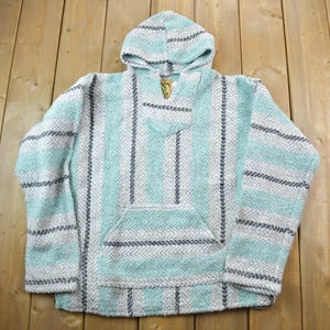 May include: A hooded turquoise and white striped cotton pullover with a pocket.