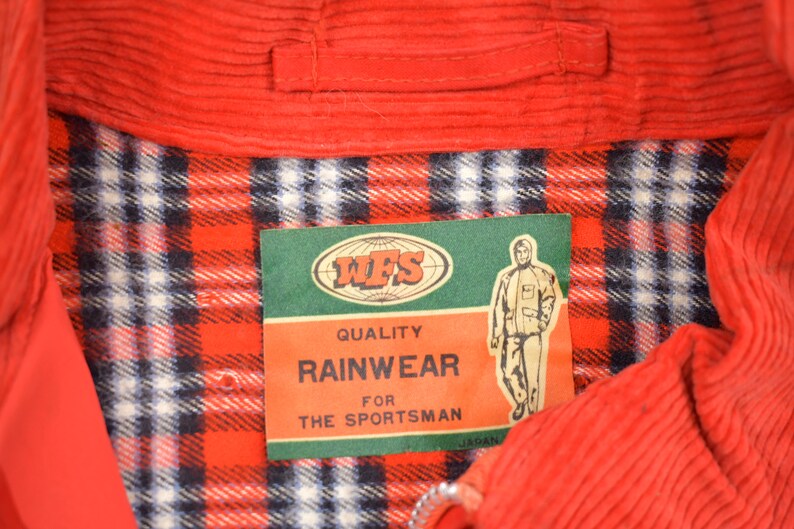 May include: Red corduroy jacket with a plaid lining and a label that reads "WFS Quality Rainwear for the Sportsman".