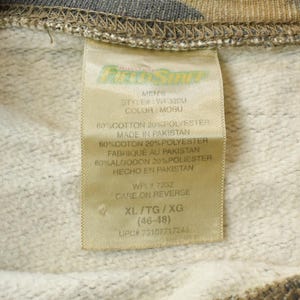 May include: A close-up of a clothing label, tan in colour, with black text. The label reads "MENNS", "STYLE: WF3200", and "COLOR: MOBU". It details the fabric composition as 80% cotton and 20% polyester. The size is XL/TG/XG (46-48).