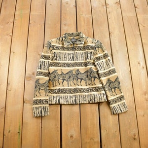 May include: A brown and black jacket with a zipper closure and a zebra print pattern. The jacket has long sleeves and a collared neckline.