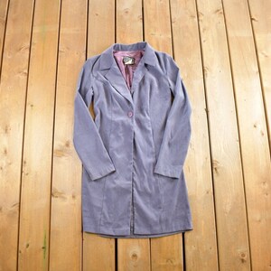 May include: A long-sleeved, light purple corduroy jacket with a single button closure.