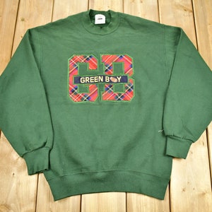 May include: Green sweatshirt with a large red and black plaid "GB" logo with the text "GREEN BOY" inside the logo.