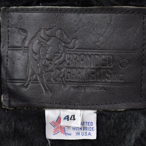 May include: A black leather label with a bull logo and the text "Branded Garments Inc."  A white label with a star and the text "44" and "Crafted with pride in U.S.A."