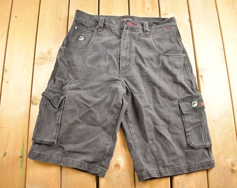 May include: Black cargo shorts with a red and white logo on the right leg. The logo says "JEEP".