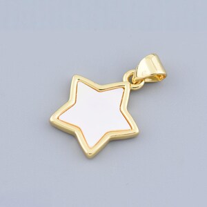 May include: A gold-tone star-shaped pendant with a white mother-of-pearl center.