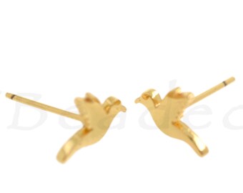 May include: A pair of gold-toned bird stud earrings. The earrings are small and delicate, with a simple design.