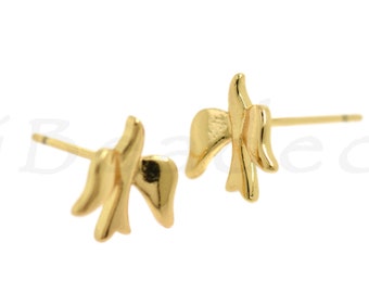 May include: A pair of gold-toned earrings with a simple, abstract design. The earrings are small and delicate, and they would be a great addition to any jewelry collection.