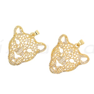 May include: Two gold-tone pendant charms in the shape of a jaguar's head, each with a detailed design and clear rhinestones.