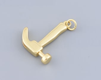 May include: A gold-colored hammer charm with a loop for attaching to a necklace or bracelet.