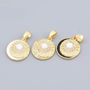 May include: Three gold-colored pendants with celestial designs. Each pendant features a central pearl-like bead surrounded by a sunburst or crescent moon design, accented with small crystals. The pendants are suitable for jewelry making.
