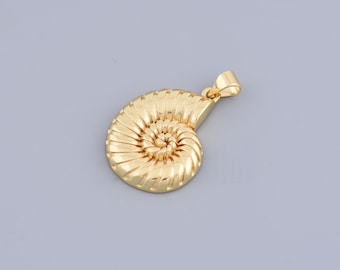 May include: A gold-coloured pendant shaped like a nautilus shell. The shell is detailed with ridges and a spiral pattern.