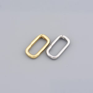 Rektangulärt ovalt spänne i guldfinish med fjädermekanism, perfekt för modulär smyckesmontering, 19,5x10,5 mm