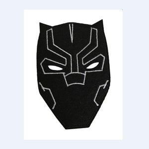 May include: Black felt patch with a white embroidered design of a superhero mask. The mask has a sharp, angular shape with a pointed chin and a prominent brow.