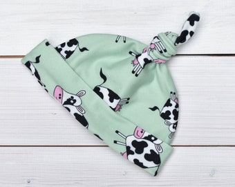 Happy cow, knotted tie top beanie hat