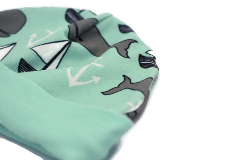 Turquoise whale unisex baby beanie hat with whale and boat design