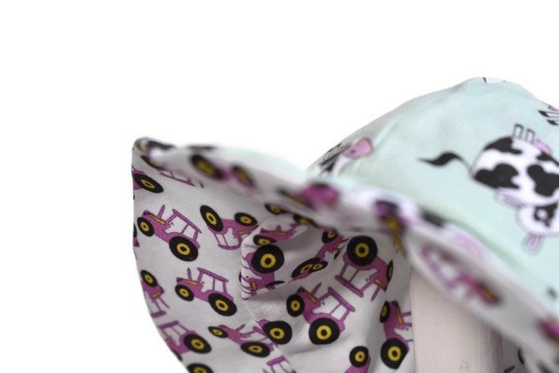 Handmade reversible cotton Sun hat with pink tractors and cows