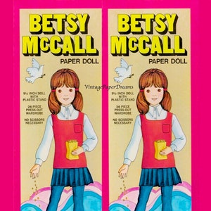 Może przedstawiać: Opakowanie papierowej lalki Betsy McCall w stylu vintage. Ilustracja przedstawia dziewczynkę w czerwonej kamizelce, niebieskiej spódniczce i turkusowych rajstopach. Opakowanie zawiera lalkę o wysokości 24 cm z plastikową podstawką i 26-częściową garderobą do wycięcia. Tekst brzmi "Papierowa lalka Betsy McCall".