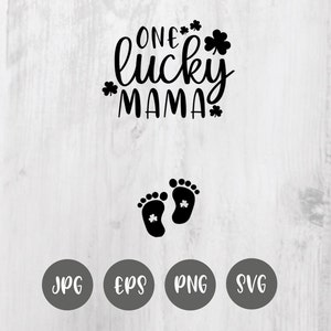 May include: Black and white graphic design with the text "One lucky mama" with shamrock symbols. Below the text are two black footprints with shamrock symbols inside each footprint. The graphic is on a white wood background with the words JPG, EPS, PNG, and SVG in black circles below the graphic.