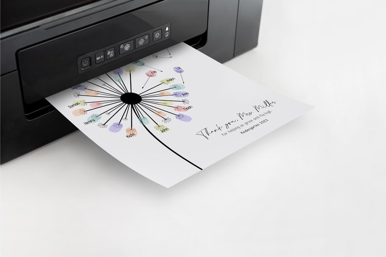 May include: A white print emerging from a black printer features a dandelion design with colorful fingerprints and names. The text reads "Thank you, Miss Miller for helping us grow and fly high Kindergarten 2023."