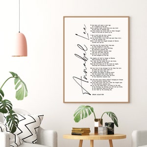 May include: A black and white printable wall art print featuring the poem "Annabel Lee" by Edgar Allan Poe. The poem is printed in a classic font and is framed in a simple black frame.