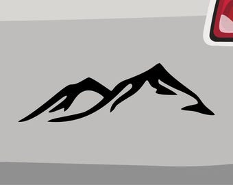 May include: A black silhouette of a mountain range with two peaks. The mountain range is isolated against a gray background.