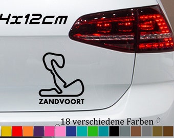 May include: A white car with a black outline of the Zandvoort race track and the text "Zandvoort" and "14x12cm". Below the car is a row of 18 color swatches.
