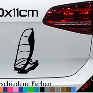 May include: Black silhouette of a windsurfer on a white car with the text "20x11cm" and "21 verschiedene Farben" in black. The car has a red taillight and the text "NEU! Neonfarben" in yellow, red, and green.