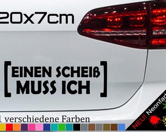 May include: A black and white sticker with the text "[EINEN SCHEIß] MUSS ICH" in a bold font. The sticker is 20 cm by 7 cm and is shown on the back of a white car. The text "21 verschiedene Farben" is below the sticker, and a row of 21 colored squares is below the text.