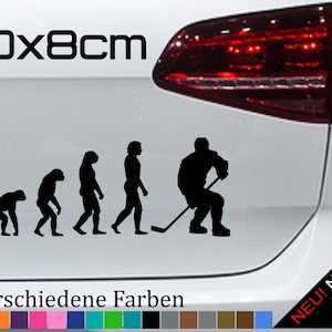 May include: A black and white evolution of hockey sticker with the text "20x8cm" and "21 verschiedene Farben". The sticker shows a series of stick figures evolving from a monkey to a hockey player holding a stick. The sticker is on a white car.