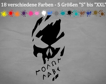 May include: Black skull graphic with the text "ΜΟΛΩΝ ΛΑΒΕ" in Greek letters. The graphic is available in 18 colors and 5 sizes, from S to XXL.